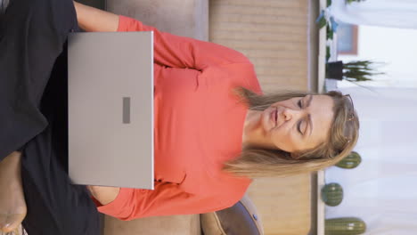Vertical-video-of-Woman-looking-at-laptop-is-unmotivated-and-bored.